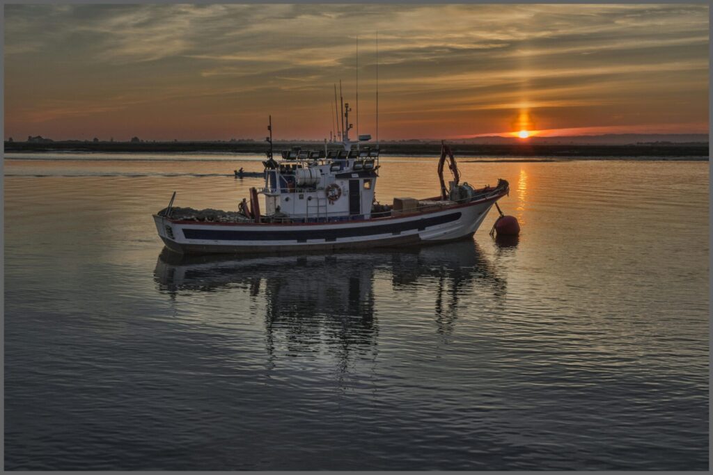 Commercial fishing boat equipped with durable marine ropes and safety gear, navigating coastal waters